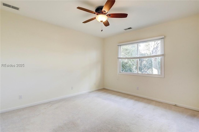 carpeted spare room featuring ceiling fan