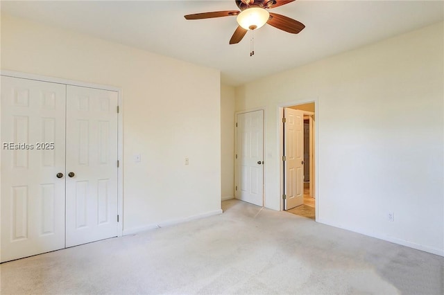 unfurnished bedroom featuring ceiling fan and light carpet