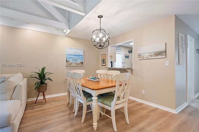 dining room featuring a notable chandelier, lofted ceiling with beams, and light wood-type flooring