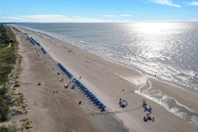 drone / aerial view featuring a water view and a beach view