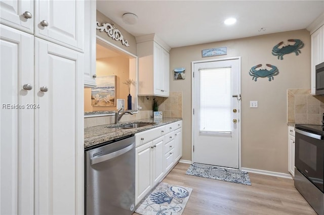 kitchen featuring white cabinetry, sink, and appliances with stainless steel finishes