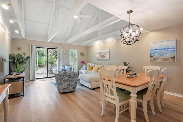 dining space featuring a notable chandelier, light hardwood / wood-style floors, and vaulted ceiling with beams