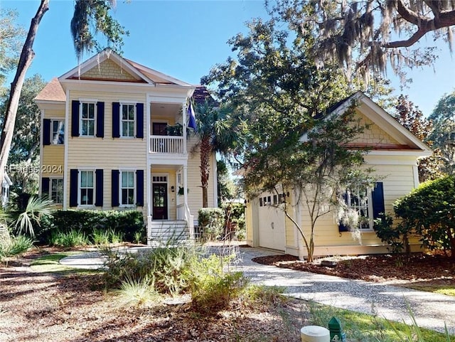 view of front of property featuring a garage and a balcony