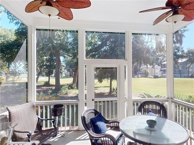 sunroom / solarium featuring ceiling fan