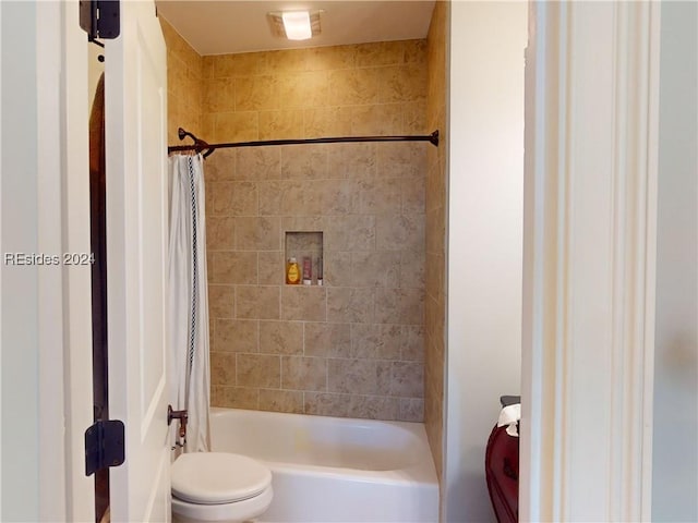 bathroom with shower / bath combination with curtain and toilet