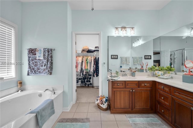 bathroom featuring tile patterned floors, shower with separate bathtub, and vanity