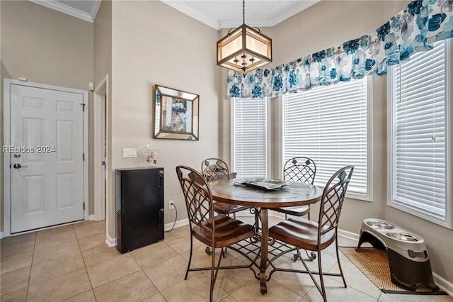 dining area featuring ornamental molding and light tile patterned floors