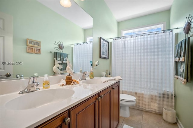 full bathroom featuring shower / tub combo with curtain, vanity, tile patterned floors, and toilet