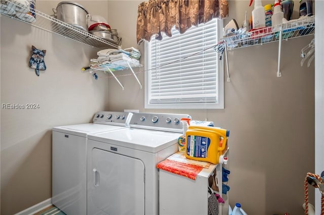 clothes washing area featuring washer and clothes dryer