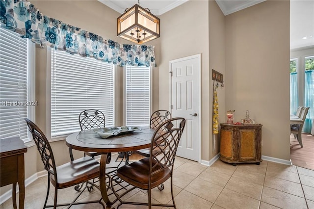 dining area featuring crown molding, a chandelier, and light tile patterned floors