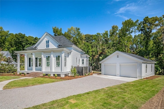 view of front of house featuring a garage, an outdoor structure, and a front lawn