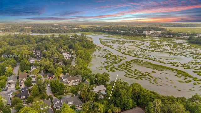 aerial view at dusk with a water view