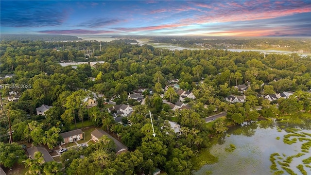 aerial view at dusk with a water view