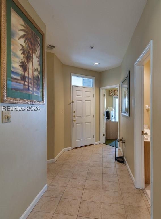 entryway with light tile patterned flooring