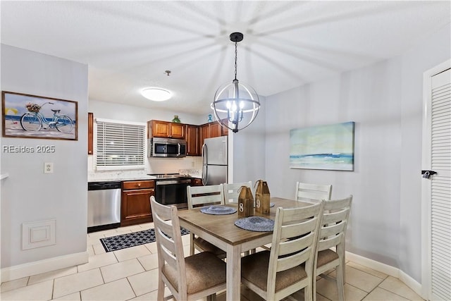 dining space featuring light tile patterned floors and a chandelier