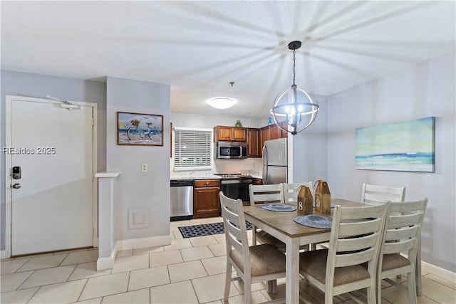 dining area featuring light tile patterned flooring and an inviting chandelier