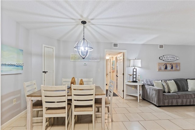 tiled dining space featuring a chandelier