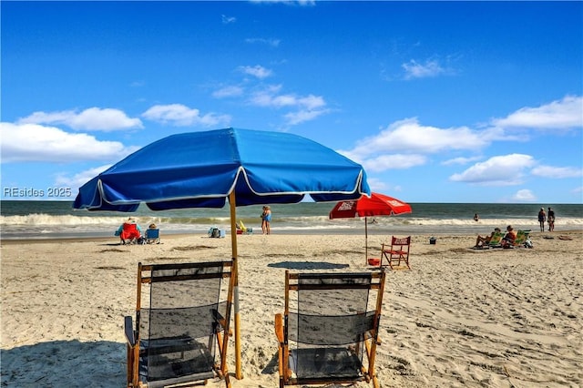 view of playground with a view of the beach and a water view