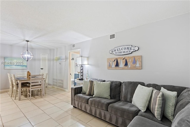 living room with light tile patterned flooring and a chandelier