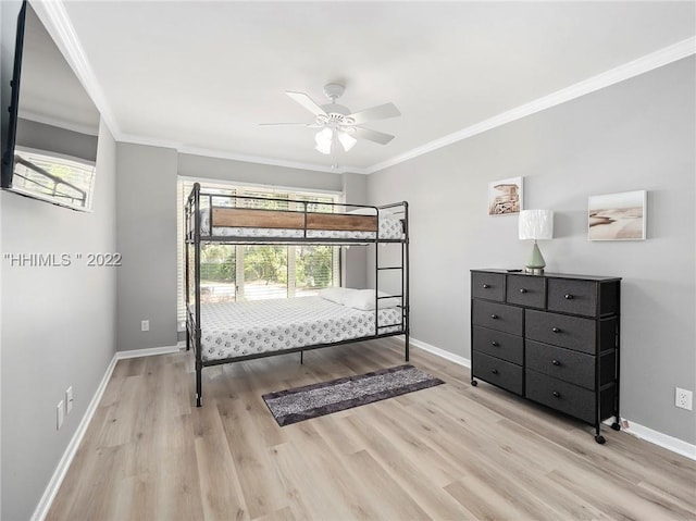 bedroom featuring ornamental molding, ceiling fan, and light hardwood / wood-style floors