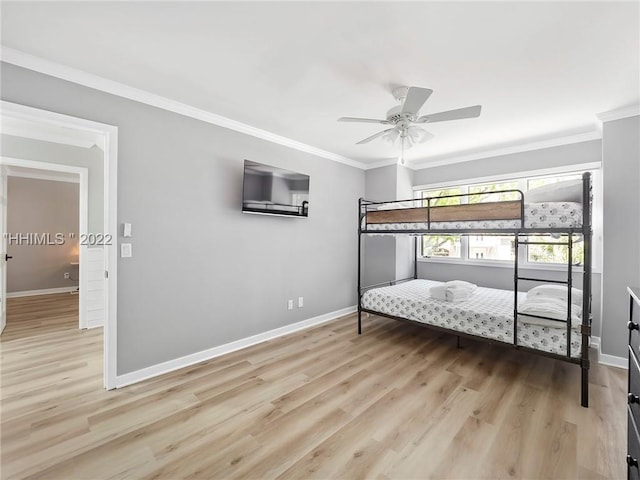 bedroom with crown molding, ceiling fan, and light hardwood / wood-style flooring