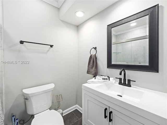 bathroom with an enclosed shower, vanity, tile patterned floors, and toilet