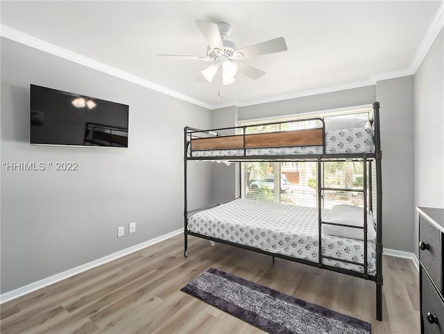 bedroom with ceiling fan, ornamental molding, and hardwood / wood-style floors