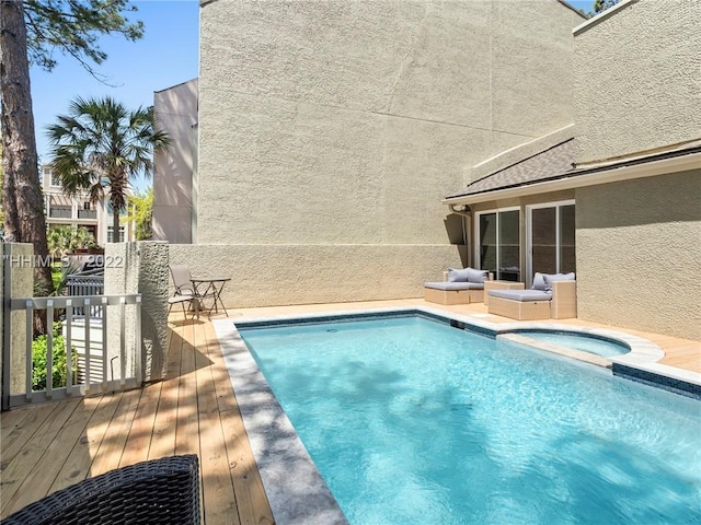 view of swimming pool with an in ground hot tub and a deck