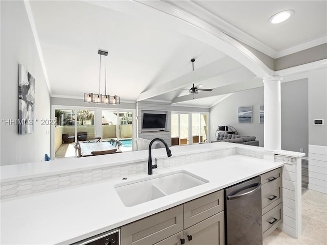 kitchen with lofted ceiling, sink, stainless steel dishwasher, pendant lighting, and decorative columns