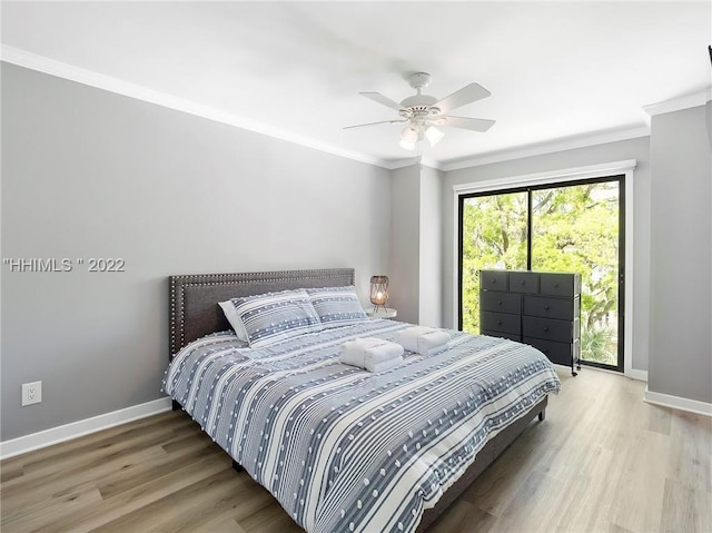 bedroom featuring hardwood / wood-style flooring, crown molding, and ceiling fan