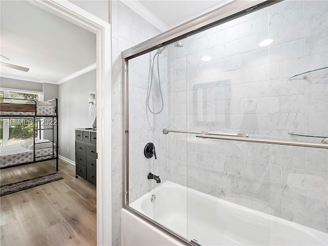 bathroom with ornamental molding, wood-type flooring, shower / bath combination with glass door, and vanity