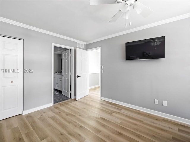 unfurnished bedroom featuring crown molding, wood-type flooring, ceiling fan, and ensuite bathroom