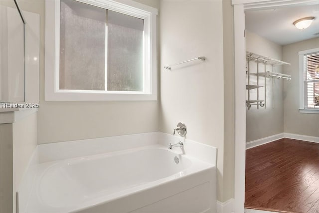 bathroom featuring a bath and hardwood / wood-style flooring