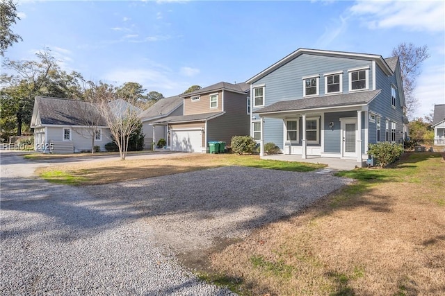 view of front property featuring a porch and a garage