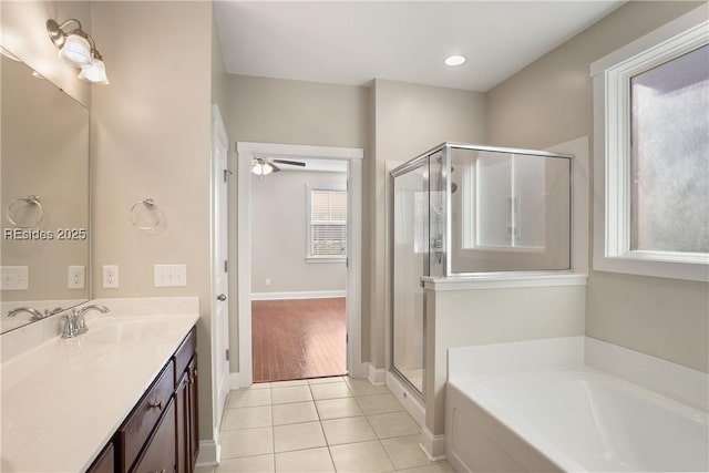 bathroom with tile patterned floors, independent shower and bath, and vanity