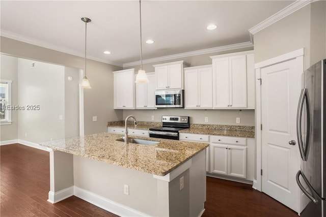 kitchen featuring hanging light fixtures, appliances with stainless steel finishes, a kitchen island with sink, and white cabinets