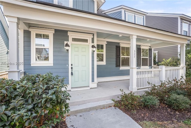 view of exterior entry featuring a porch