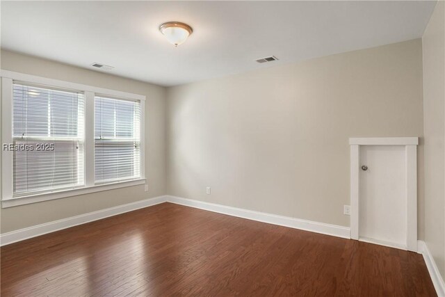 empty room featuring dark hardwood / wood-style floors