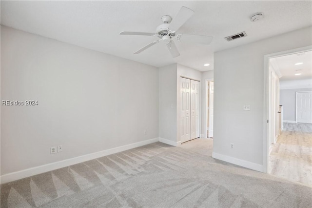 carpeted empty room with ceiling fan