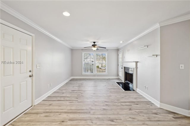 unfurnished living room featuring ceiling fan, ornamental molding, and light wood-type flooring