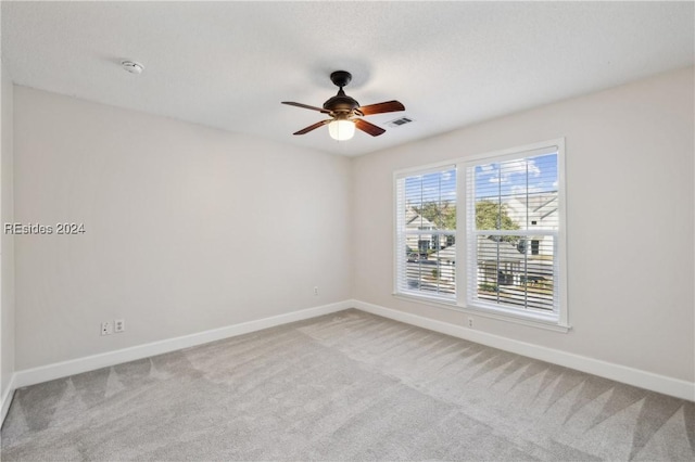 carpeted empty room featuring ceiling fan