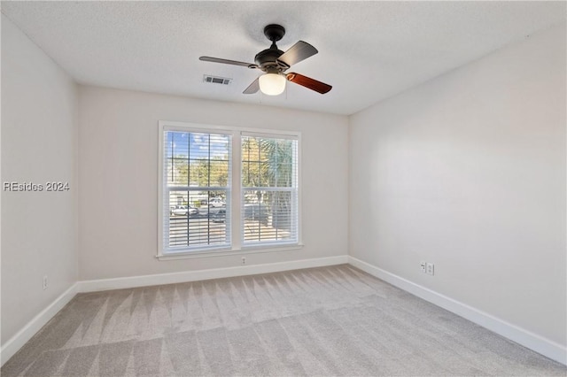 unfurnished room featuring light colored carpet and ceiling fan