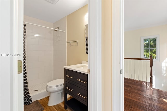 bathroom featuring wood-type flooring, toilet, curtained shower, and vanity