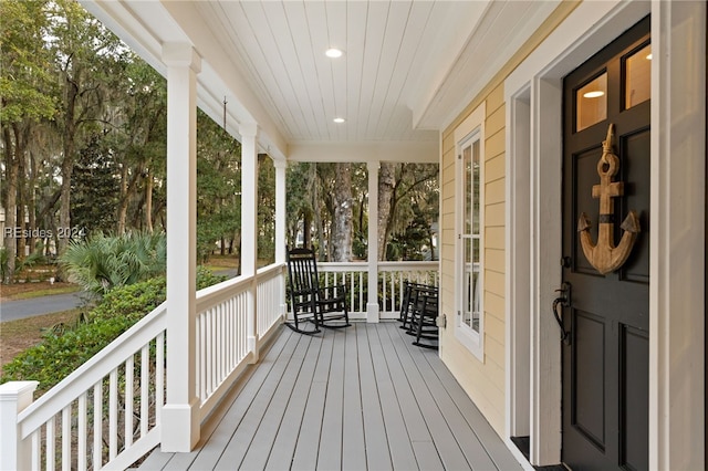 wooden terrace with a porch