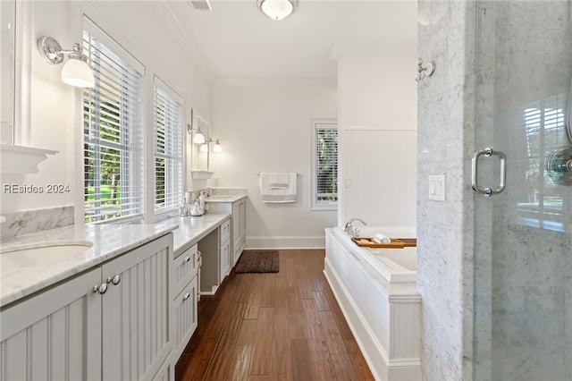 bathroom featuring independent shower and bath, crown molding, wood-type flooring, and vanity