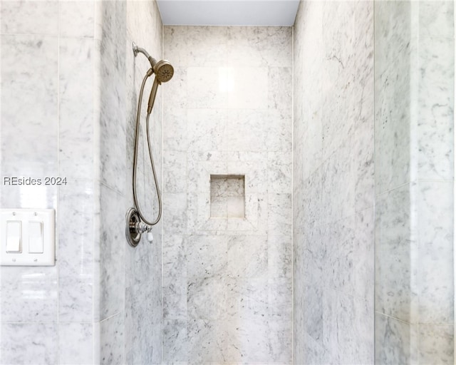 bathroom with tiled shower