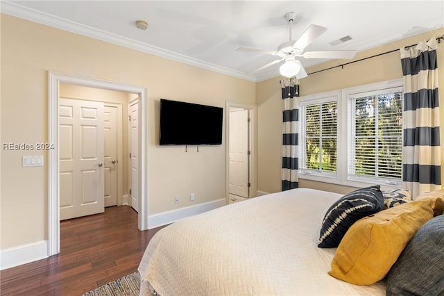 bedroom featuring dark wood-type flooring, ceiling fan, and crown molding