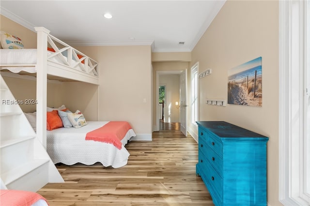 bedroom with hardwood / wood-style flooring and crown molding