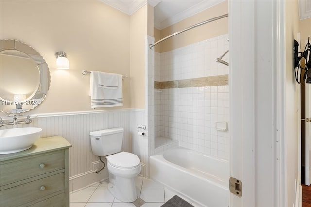 full bathroom featuring tile patterned floors, toilet, crown molding, vanity, and tiled shower / bath combo