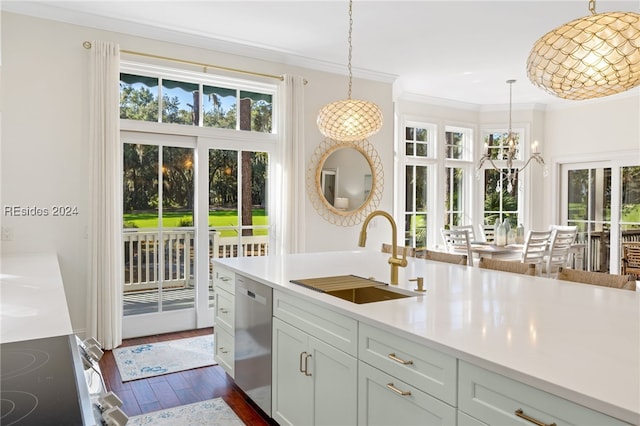 kitchen with stainless steel appliances, ornamental molding, sink, and decorative light fixtures